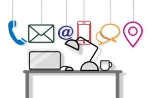 A Graphic of a Desk with strings of social and communication icons hanging above it.