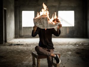Fake news: a newspaper on fire